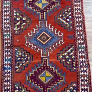 Hand-knotted Persian Afshar wool area rug 3.9' x 6.4' with a rust red field, three indigo stepped diamond medallions, and an ivory geometric border.