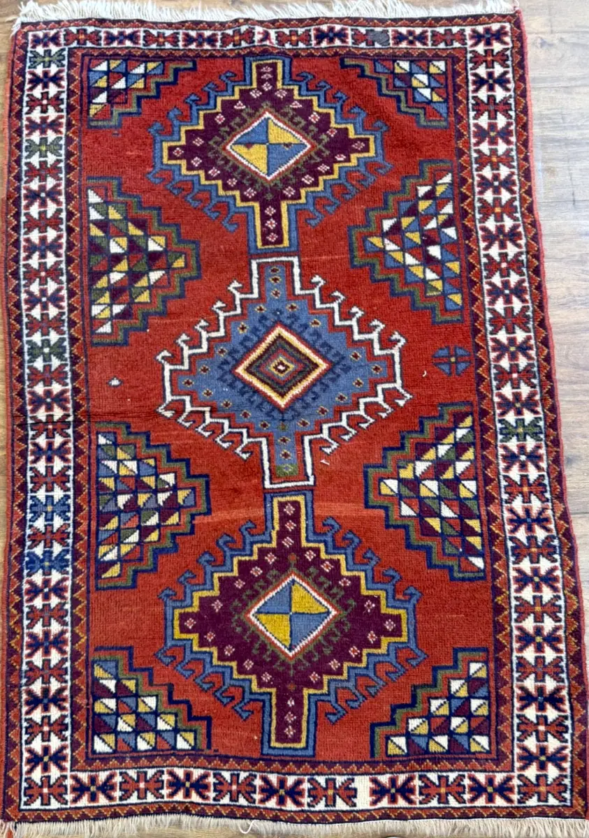 082426-2.webp | McFarlands Carpet and Rug Service Hand-knotted Persian Afshar wool area rug 3.9' x 6.4' with a rust red field, three indigo stepped diamond medallions, and an ivory geometric border.