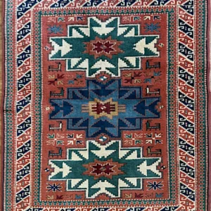 Hand-knotted Turkish Anatolian wool area rug 3.9' x 5' featuring a coral field with three stepped star medallions in teal, blue, and ivory.