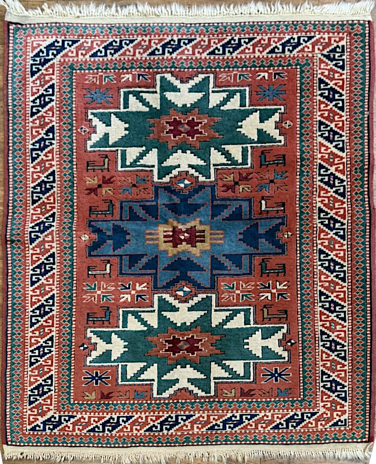 082426-4.webp | McFarlands Carpet and Rug Service Hand-knotted Turkish Anatolian wool area rug 3.9' x 5' featuring a coral field with three stepped star medallions in teal, blue, and ivory.