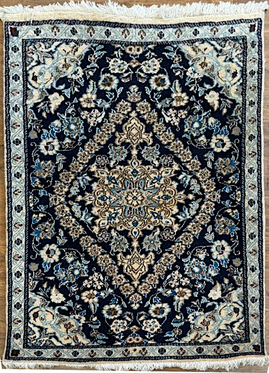 082426-5.webp | McFarlands Carpet and Rug Service Hand-knotted Persian Nain wool and silk area rug 3' x 4.5' with a midnight navy field, ivory star medallion, ice blue floral borders, and silk highlights.