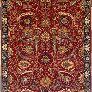 Ruby red hand-knotted Chobi wool area rug 8.2' x 9.7' with a symmetrical floral pattern and a dark midnight navy blue border.