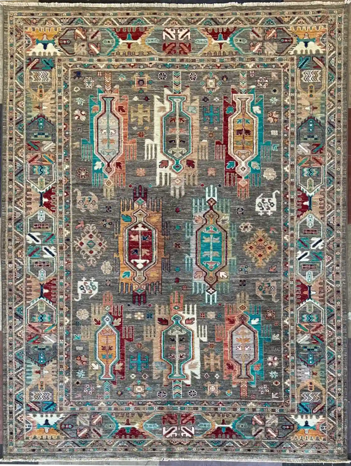 hand-knotted-chobi-wool-area-rug-5-8-x-7-10-charcoal-grey-tribal-medallions-sku-112525-19.webp | McFarlands Carpet and Rug Service Charcoal grey hand-knotted Chobi wool area rug 5.8' x 7.10' featuring eight prominent geometric tribal medallions in turquoise, terracotta, and burgundy.