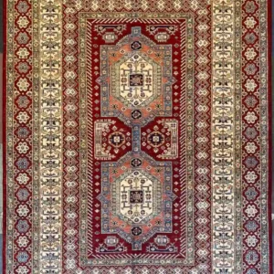 geometric-kazak-wool-rug-6x9.webp | McFarlands Carpet and Rug Service Red and ivory geometric hand-knotted Kazak wool area rug 5.11' x 8.10' showcasing a vertical double medallion tribal motif.