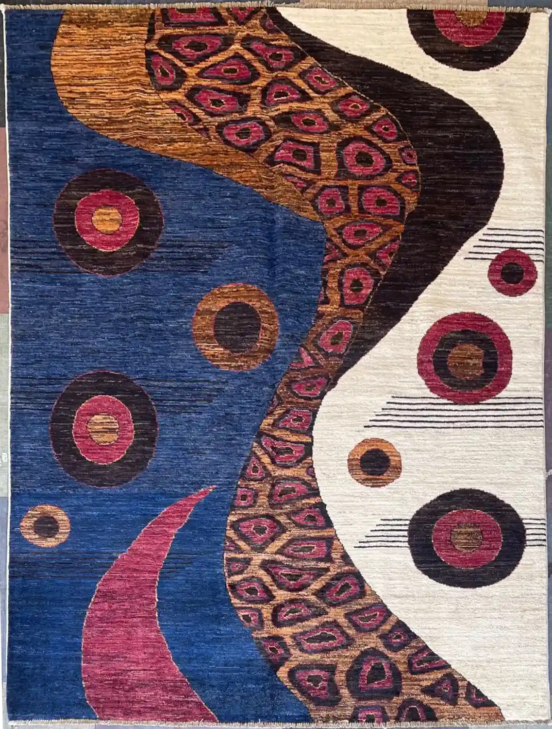 Abstract Organic Modern Wool Rug | 5.10' x 7.9'. | McFarlands Carpet and Rug Service Contemporary abstract hand-knotted wool area rug 5.10' x 7.9' featuring a split blue and cream design with a winding magenta cell band.