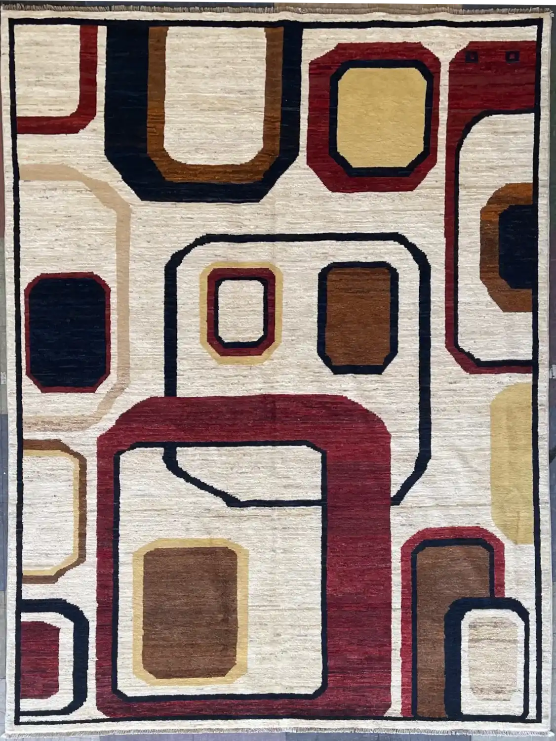mid-century-modern-abstract-geometric-rug-6x9.webp | McFarlands Carpet and Rug Service Red, navy, and tan abstract geometric frame hand-knotted wool area rug 5.11' x 8.2' with a Mid-Century Modern squircle pattern on a cream field.