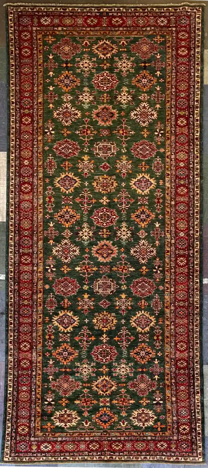 traditional-green-kazak-runner-rug.webp | McFarlands Carpet and Rug Service Traditional green Kazak hand-knotted wool runner rug 4.10' x 13' featuring geometric red and gold tribal medallions.