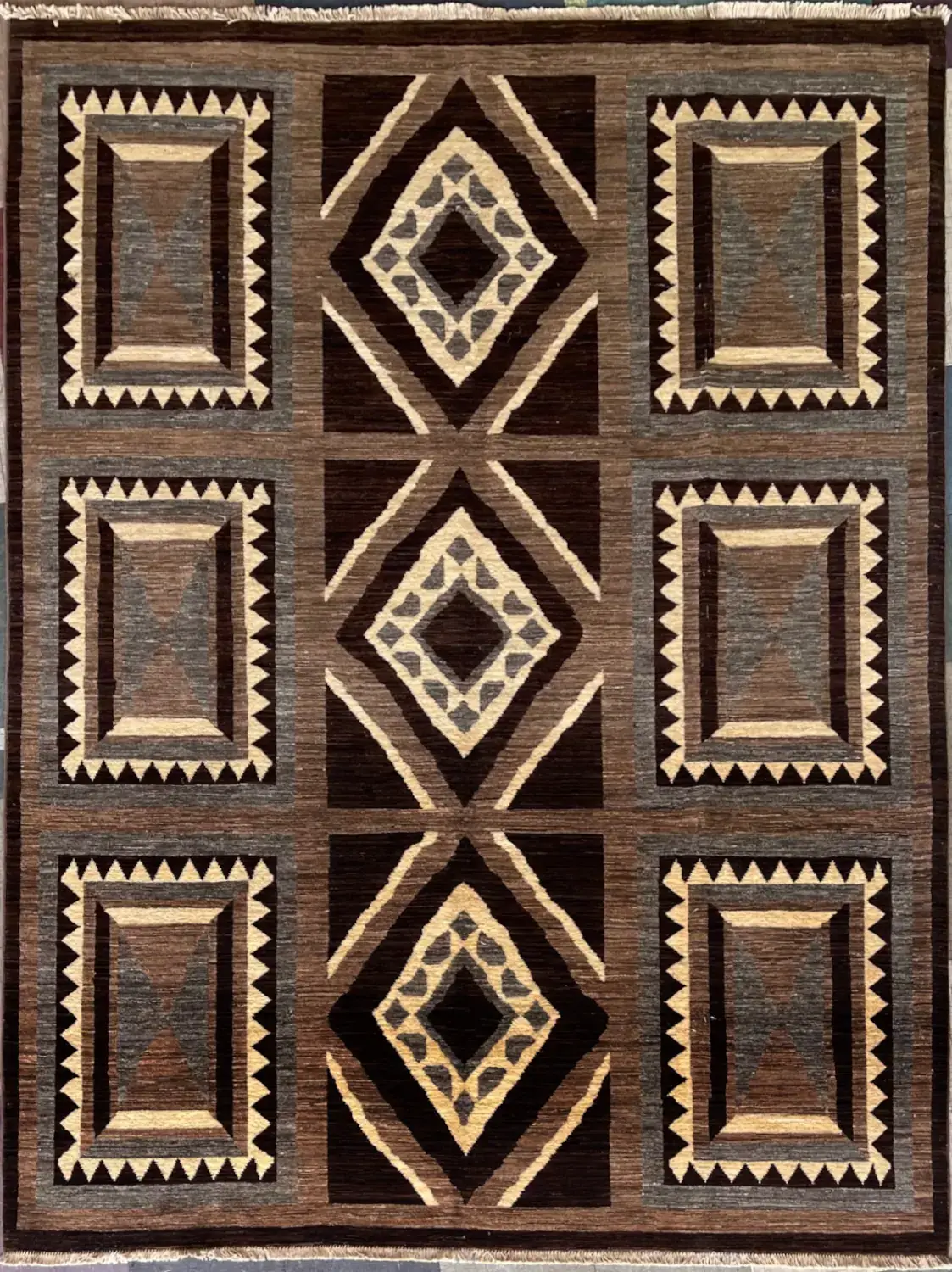 modern-geometric-espresso-charcoal-peshawar-wool-rug-6x9.webp | McFarlands Carpet and Rug Service Modern geometric Peshawar hand-knotted wool area rug 6.2' x 8.4' featuring an espresso brown and cream saw-tooth panel layout.