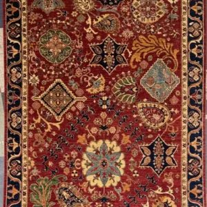 Hand-knotted Chobi wool area rug 6.0' x 9.1' featuring a crimson red field with sampler medallions and a navy blue border.