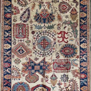 Hand-knotted Chobi wool area rug 6.2' x 9.0' featuring a golden ivory field with vibrant floral motifs and a cobalt blue border.
