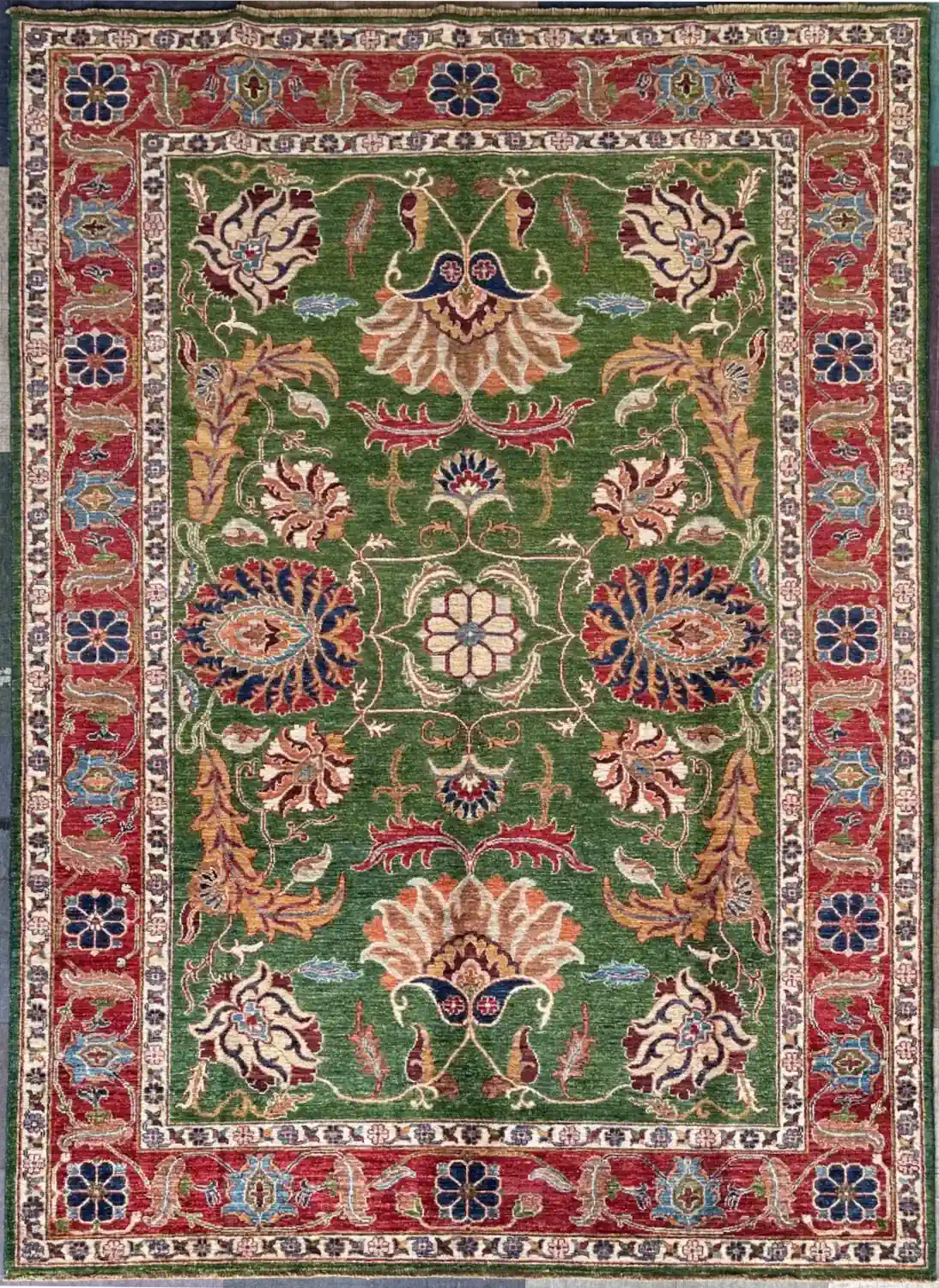 forest-green-chobi-wool-area-rug-6x9.webp | McFarlands Carpet and Rug Service Hand-knotted Chobi wool area rug 6.2' x 8.10' with a forest green field, floral palmettes, and a crimson red border.