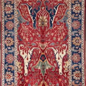 Hand-knotted Chobi wool area rug 6.2' x 8.8' featuring a crimson red field with Tree of Life branch motifs, cobalt accents, and a navy blue palmette border.