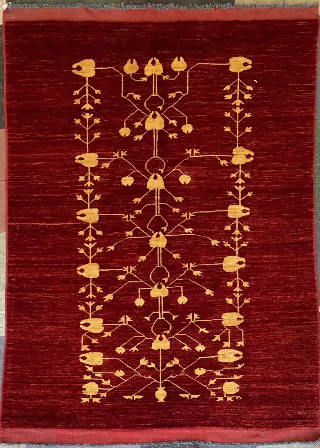modern-red-turkmen-tribal-wool-rug-5x7.webp | McFarlands Carpet and Rug Service Modern red Turkmen hand-knotted wool area rug 5.5' x 7.10' featuring a minimalist gold geometric tree of life motif.