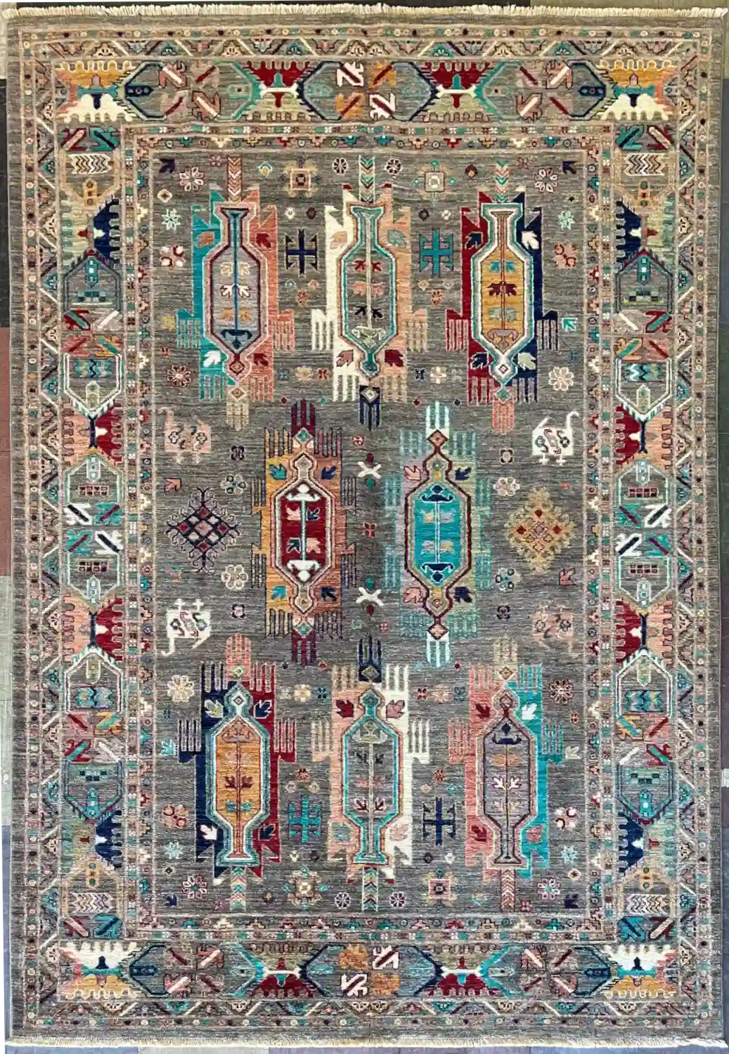 traditional-grey-chobi-peshawar-medallion-rug-5x7.webp | McFarlands Carpet and Rug Service Traditional grey Chobi Peshawar hand-knotted wool area rug 5.6' x 8.2' featuring colorful geometric cartouche medallions and a detailed border.