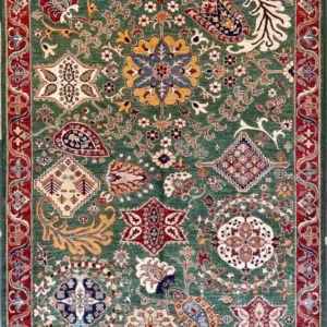 traditional-green-chobi-peshawar-floral-wool-rug-5x7.webp | McFarlands Carpet and Rug Service Traditional green Chobi Peshawar hand-knotted wool area rug 5.8' x 7.3' featuring multi-colored floral palmettes and a deep red border frame.