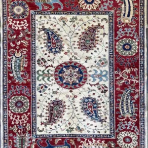 ivory-chobi-peshawar-paisley-wool-rug-5x7.webp | McFarlands Carpet and Rug Service Traditional ivory Chobi Peshawar hand-knotted wool area rug 5' x 6.6' featuring navy blue paisley motifs and a bold crimson red border frame.