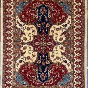 red-navy-chobi-peshawar-wool-rug-5x7.webp | McFarlands Carpet and Rug Service Traditional red and navy Chobi Peshawar hand-knotted wool area rug 4.11' x 6.7' featuring an interlocking geometric floral field and an ivory border frame.