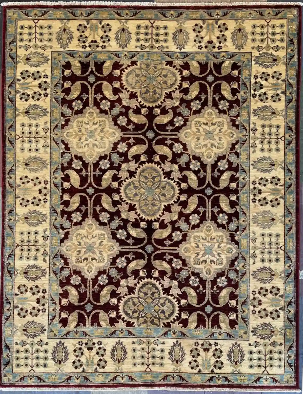 burgundy-chobi-peshawar-floral-wool-rug-5x7.webp | McFarlands Carpet and Rug Service Traditional burgundy Chobi Peshawar hand-knotted wool area rug 5.3' x 6.8' featuring a repeating cream floral medallion grid layout and a wide ivory border frame.