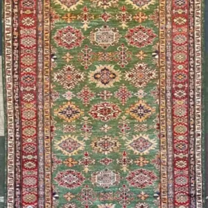 Traditional green Kazak hand-knotted wool runner rug 4.3' x 13.2' featuring a dense vertical geometric medallion layout and a wide red border frame.