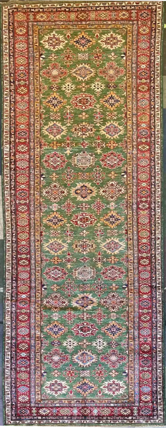 traditional-green-kazak-wool-runner-rug-4x13.webp | McFarlands Carpet and Rug Service Traditional green Kazak hand-knotted wool runner rug 4.3' x 13.2' featuring a dense vertical geometric medallion layout and a wide red border frame.