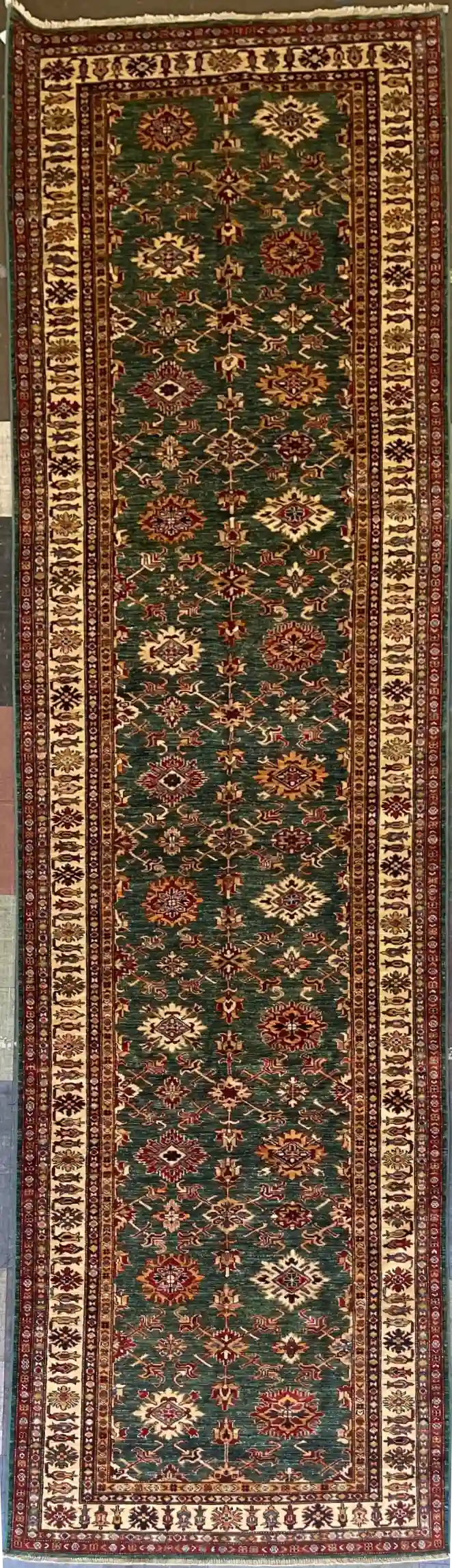 traditional-green-kazak-wool-runner-rug-4x16.webp | McFarlands Carpet and Rug Service Traditional green Kazak hand-knotted wool runner rug 4.2' x 16.2' featuring an alternating geometric medallion vertical layout and a wide cream border frame.