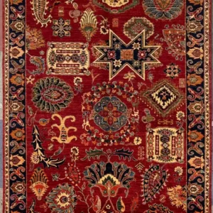 Hand-knotted Chobi Peshawar wool area rug 6.8' x 9.2' with crimson red field, geometric star sampler motifs, and a navy blue border.