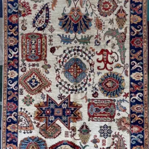 Hand-knotted Chobi Peshawar wool area rug 6.4' x 9.0' with ivory field, tribal sampler motifs, geometric star emblem, and cobalt blue border.