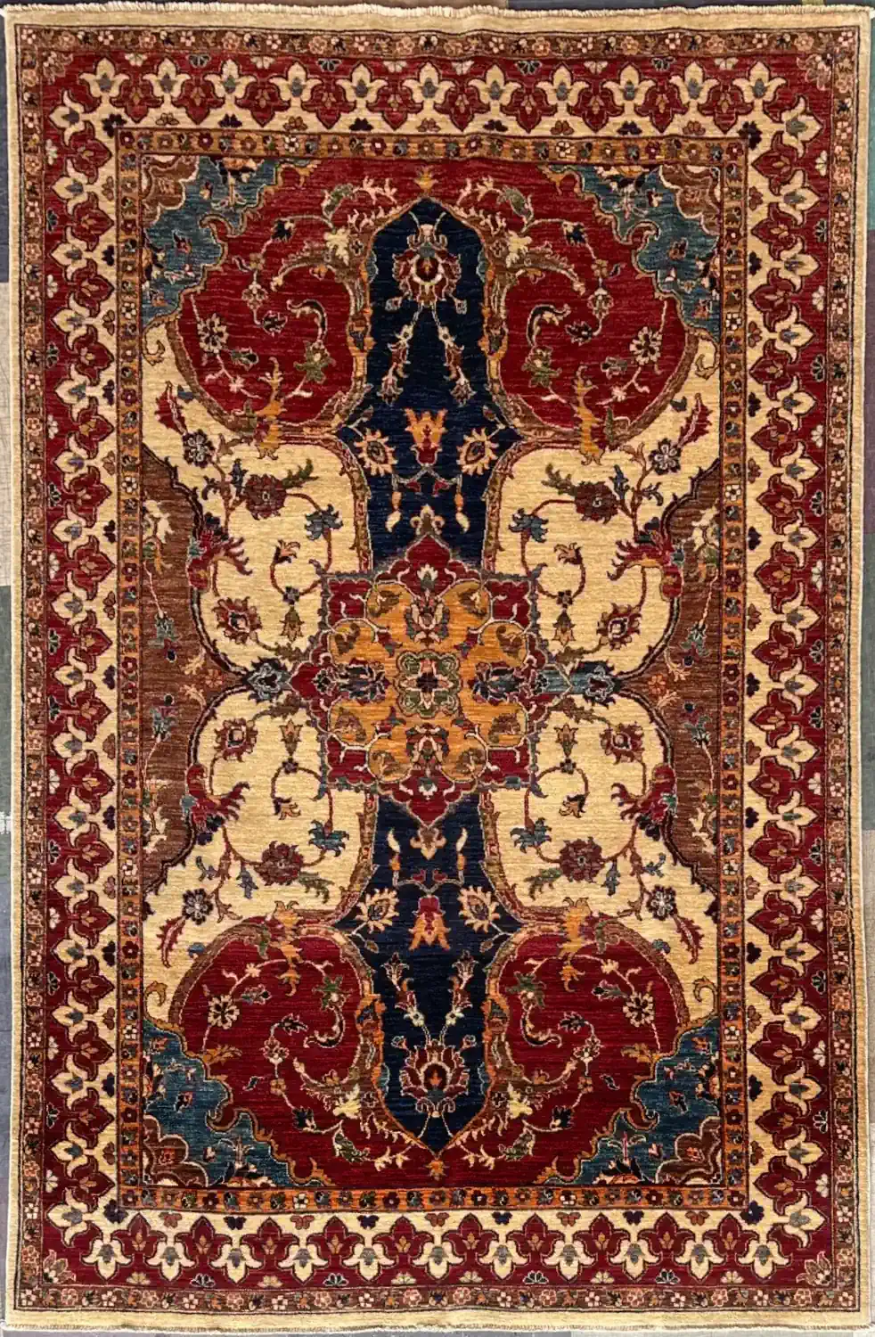 Oriental rug with a central navy medallion, cream field, and scrolling floral motifs; red and gold border. | McFarlands Carpet and Rug Service Oriental rug with a central navy medallion, cream field, and scrolling floral motifs; red and gold border.